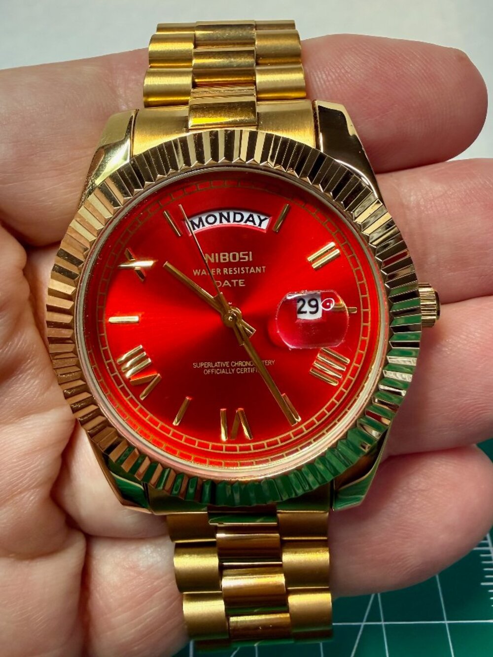 Nibosi Day date gold and red quartz men's watch.